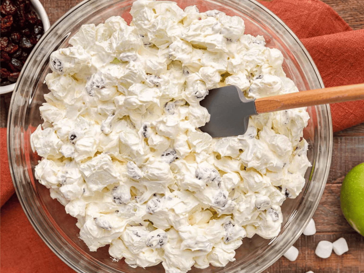 Top view of salad in bowl with spatula