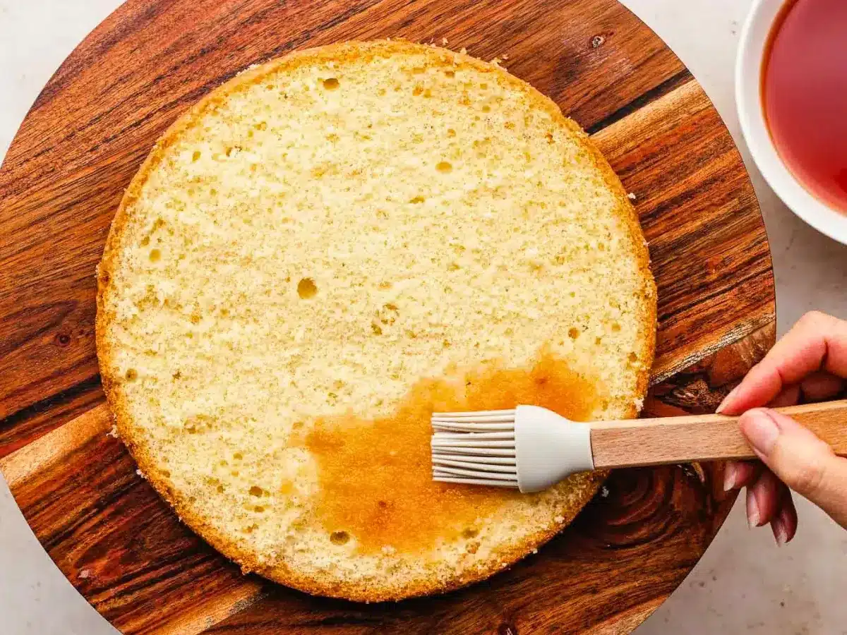 Syrup brushed onto cake