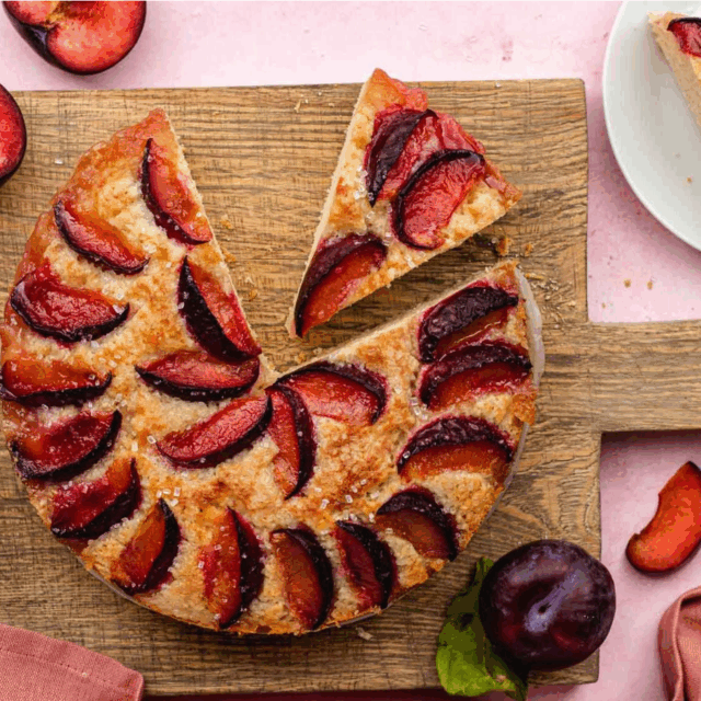 cake with piece cut and piece taken on wooden platter