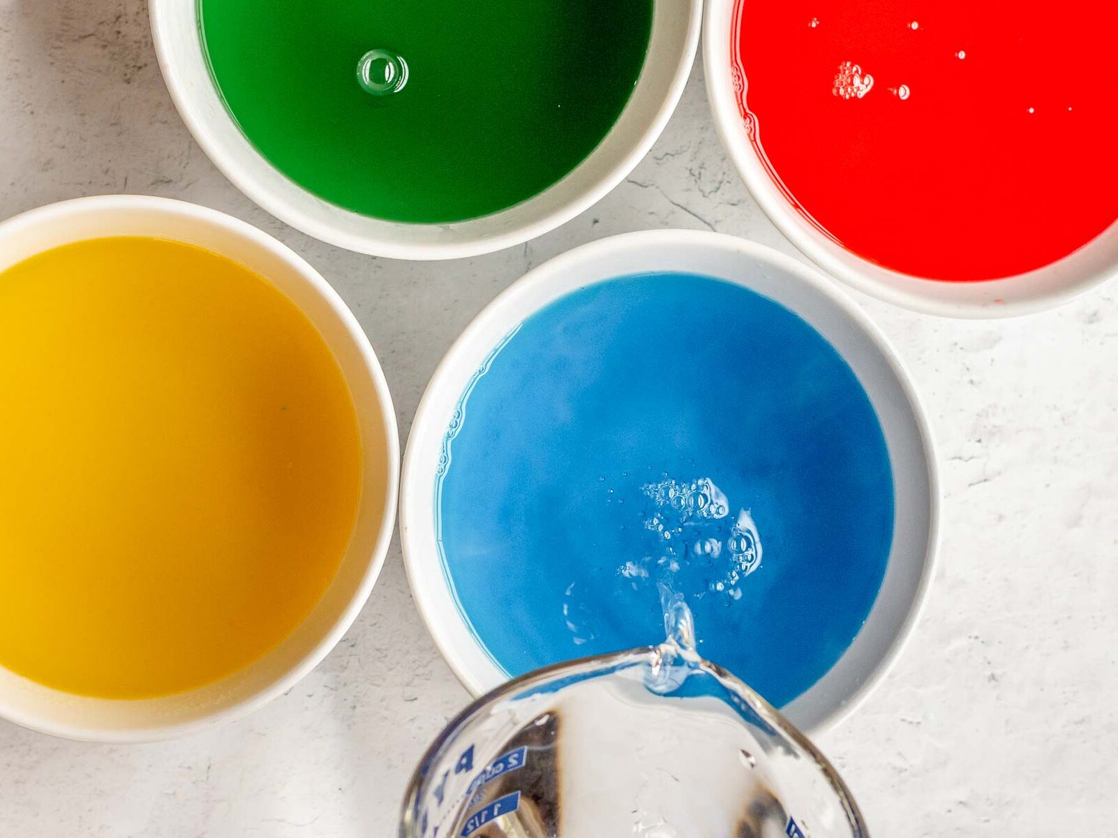 Gelatin and cold water vodka mixture being added to Jello Shots