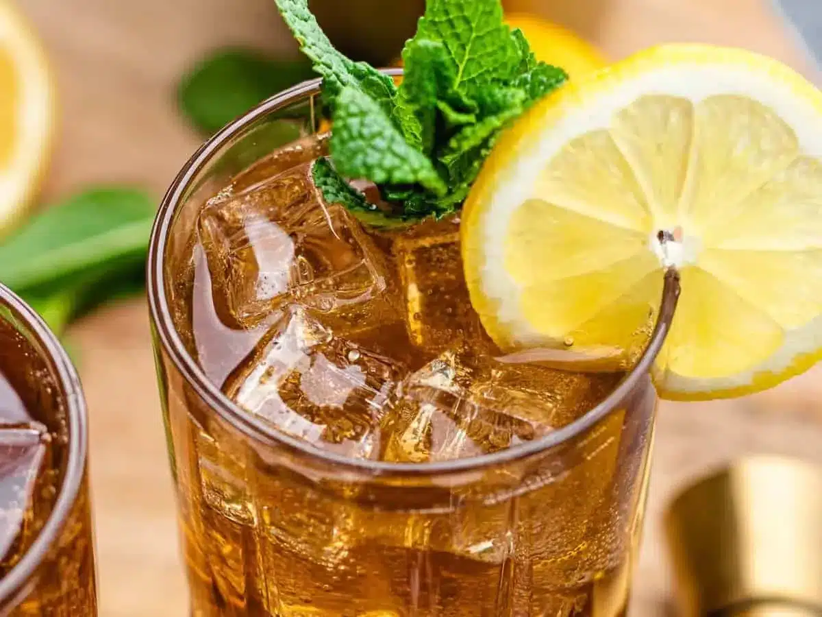 top of drink with lemon and garnish in a glass