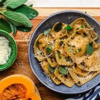 Ravioli in blue bowl on brown table