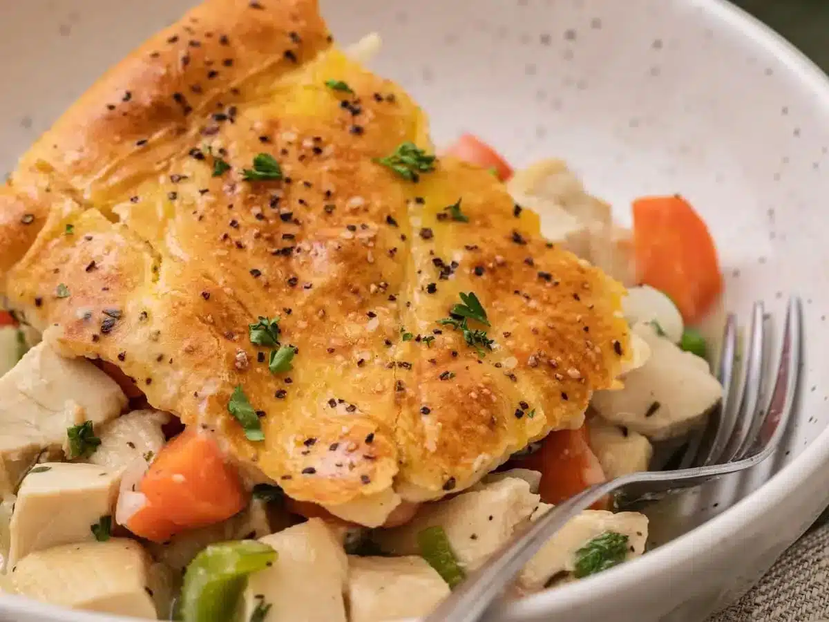 slice of casserole in a bowl with a fork