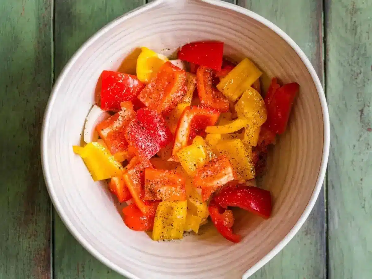 chopped peppers with seasoning in a bowl