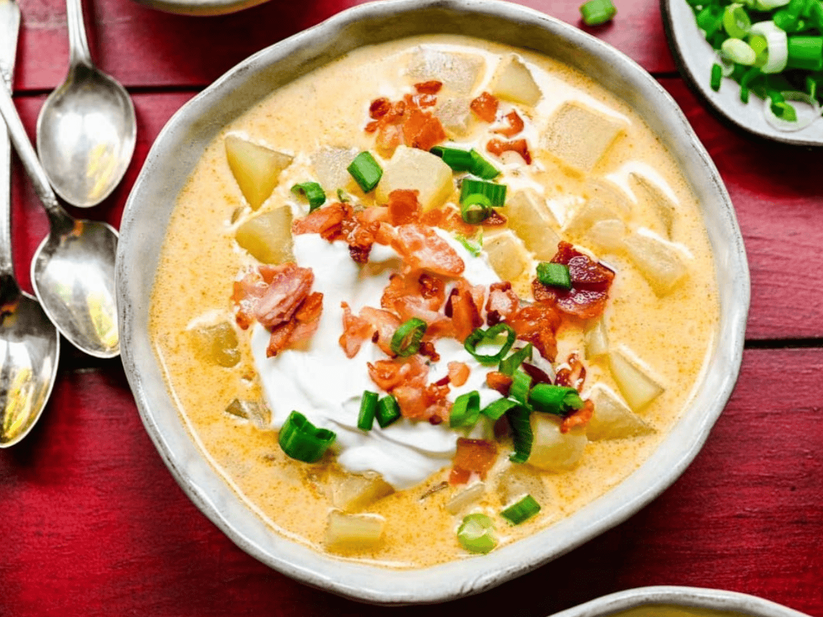 Top view of soup with spoons and toppings