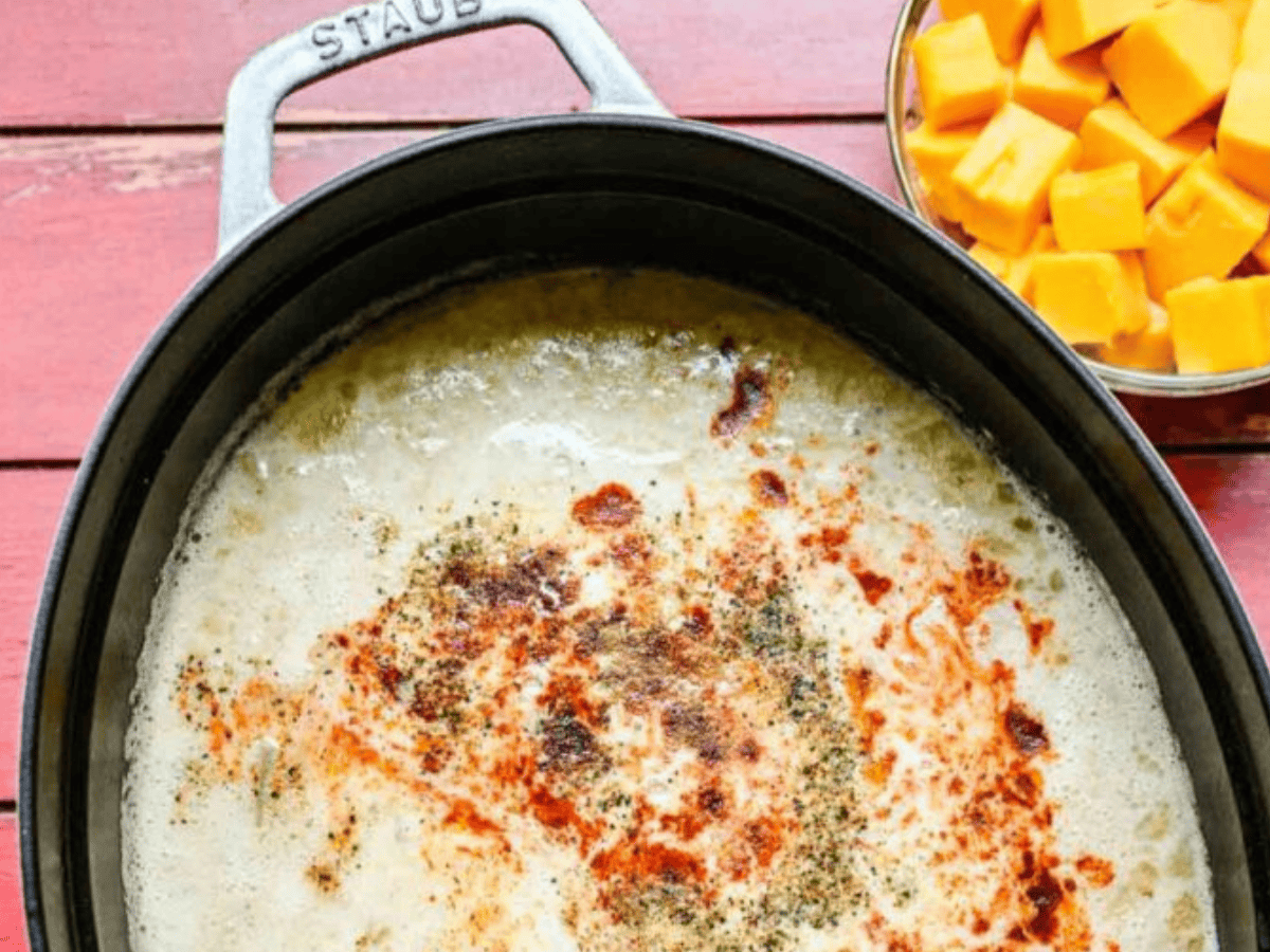 Soup in pot cooking with cheese on the side