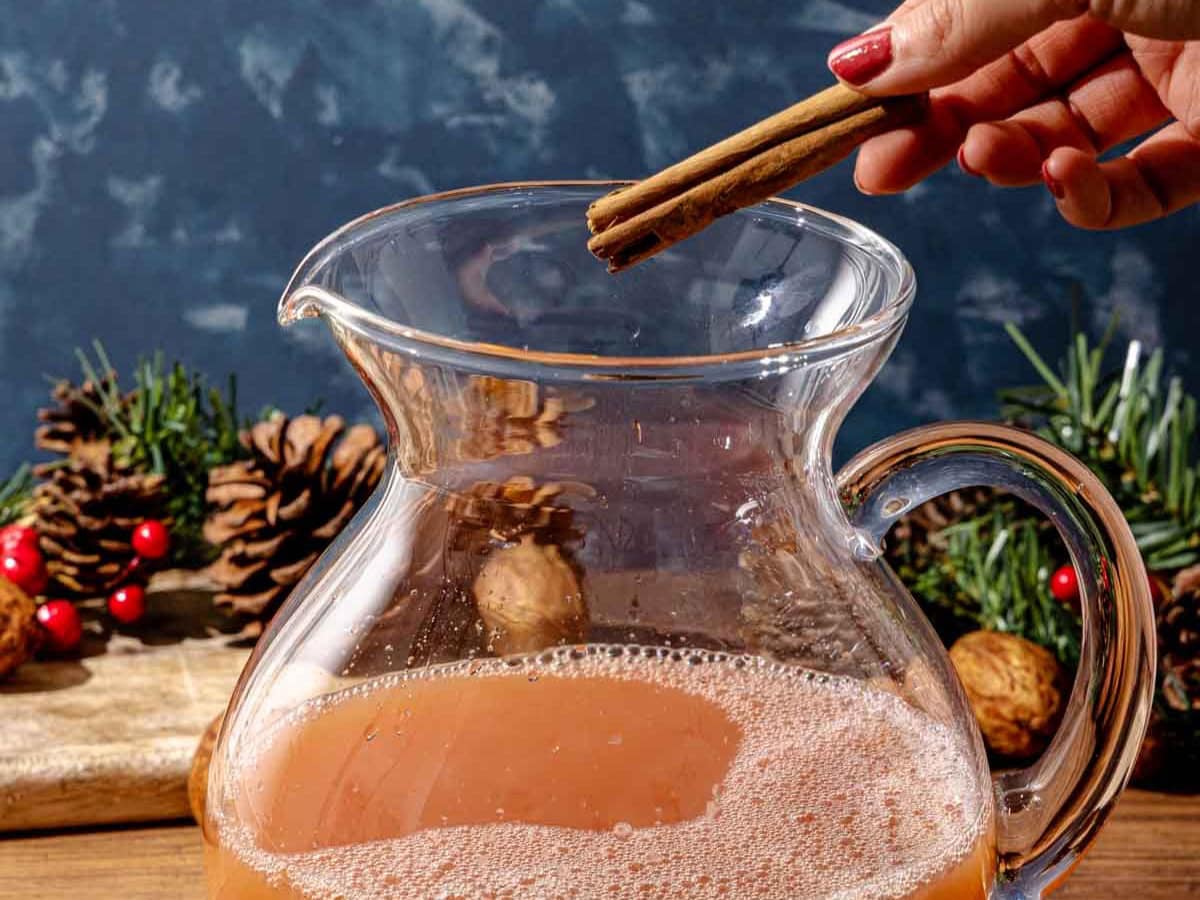 Cinnamon being dropped in the pitcher