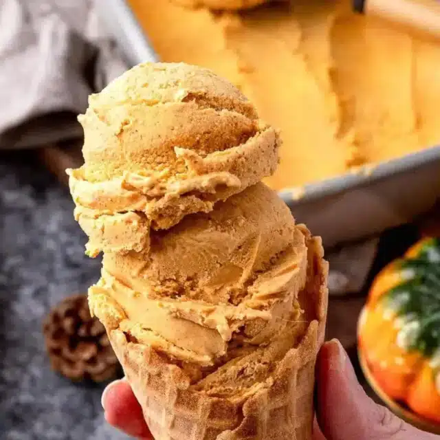 Hand holding cone with ice cream