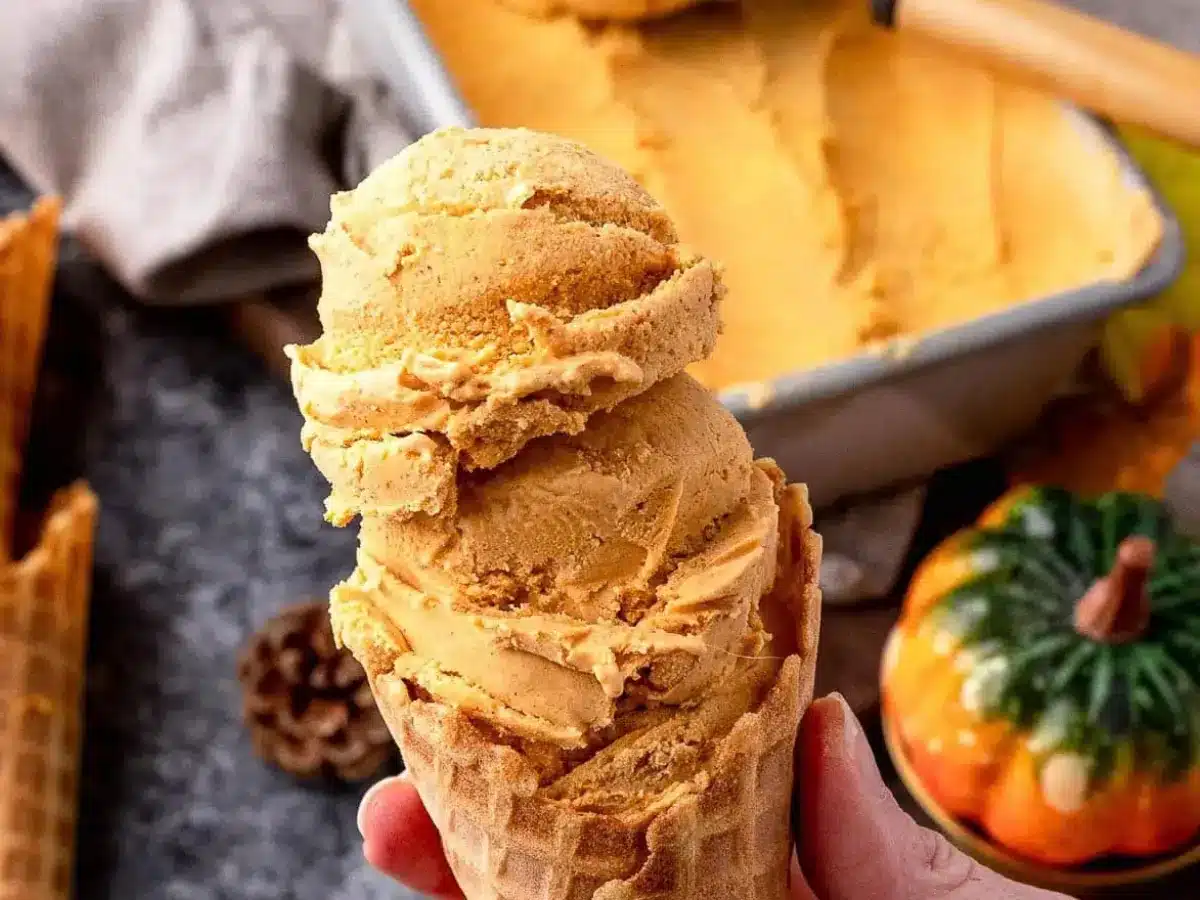 Hand holding cone with ice cream