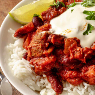 Chili in bowl on top of white rice.