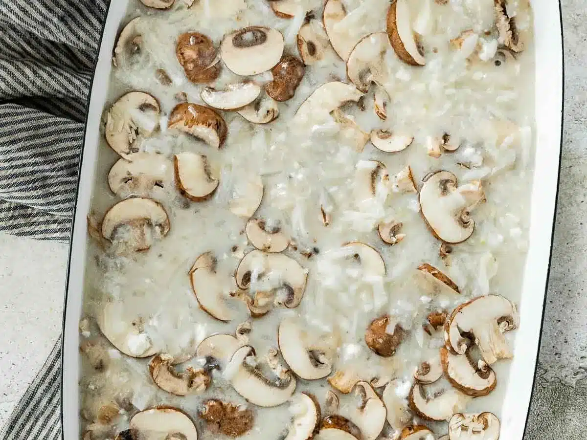 Condensed soup, mushrooms, and rice in baking dish.