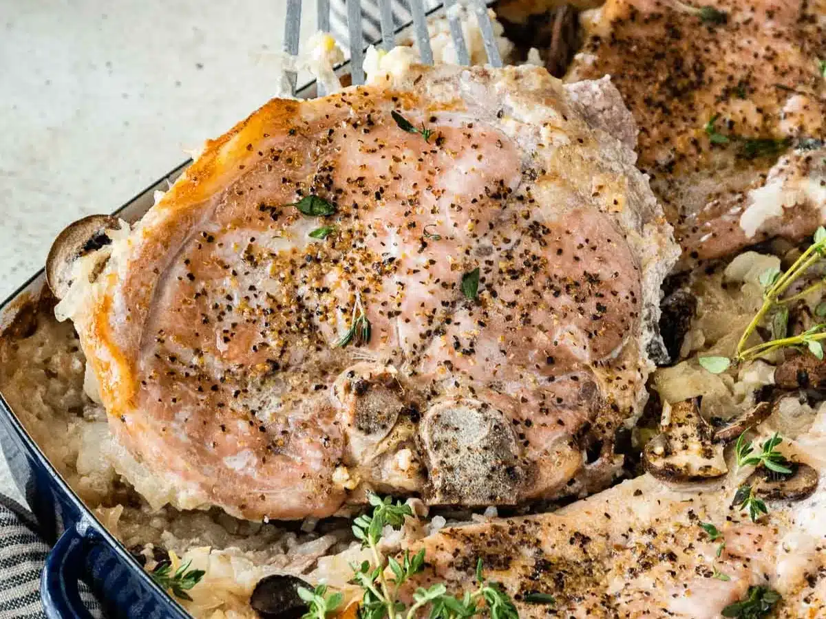 Meat chops and rice in baking dish.