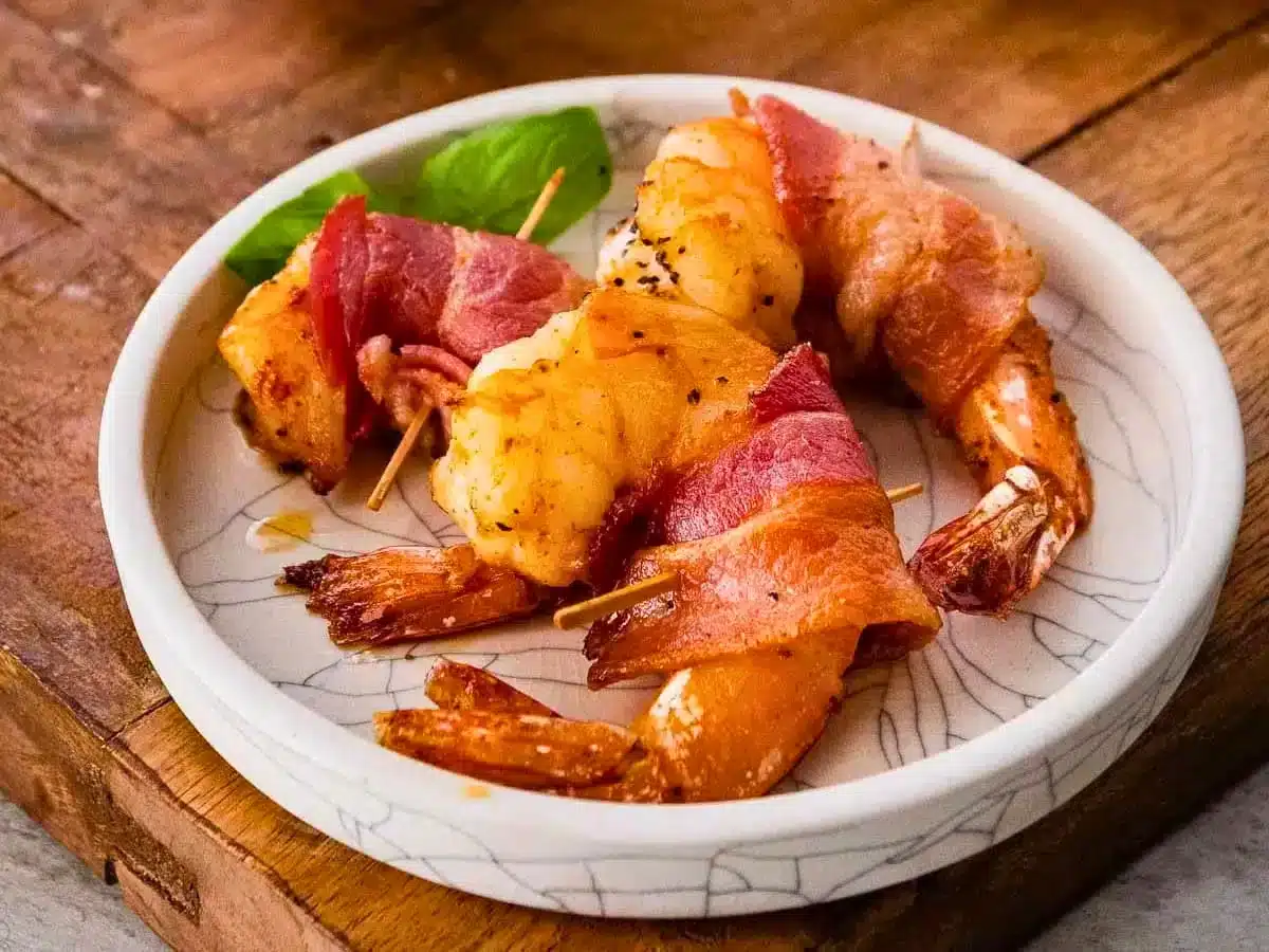 Three shrimp wrapped in bacon