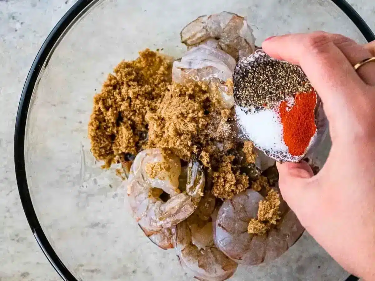 Shrimp being seasoned
