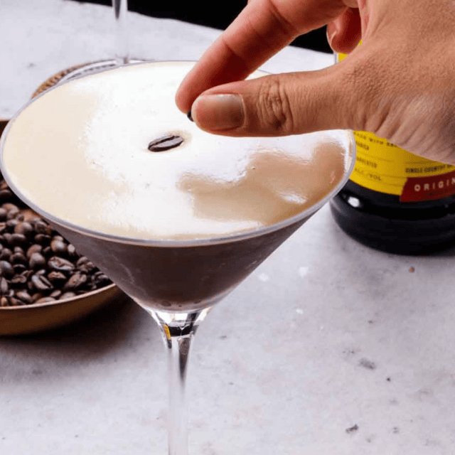 Drink with white foam and 1 coffe Bean in top