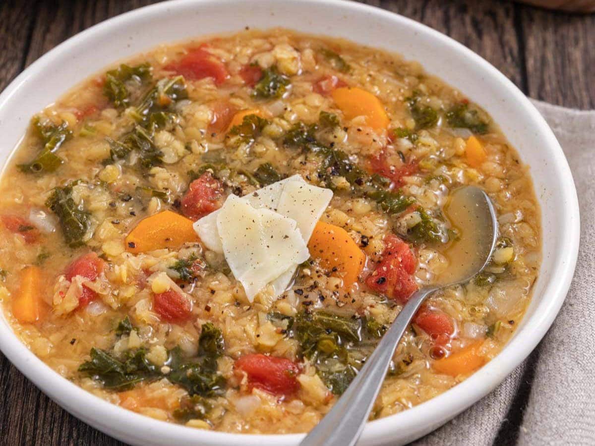 bowl of stew topped with shaved parmesean