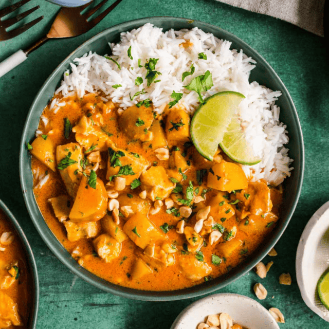 Bowl of curry with rice and lime garnish
