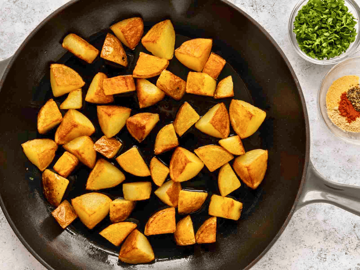 cubed potatoes cooking on a pan