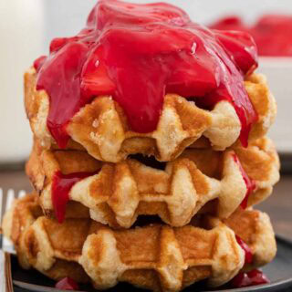 Strawberry glaze on top of waffles.