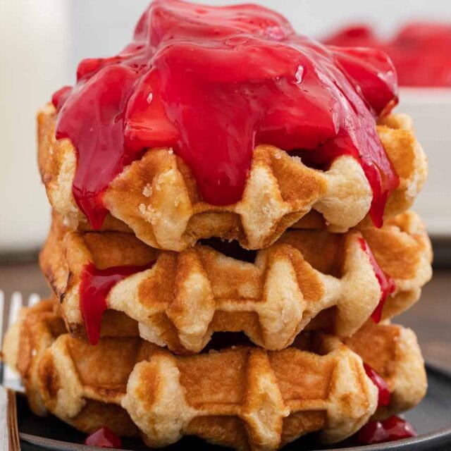 Strawberry glaze on top of waffles.
