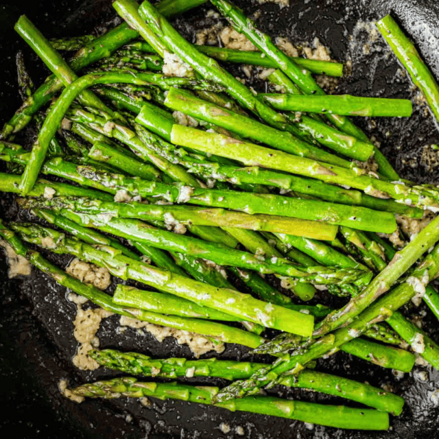 Freshly cooked long green vegetables in a cast iron skillet
