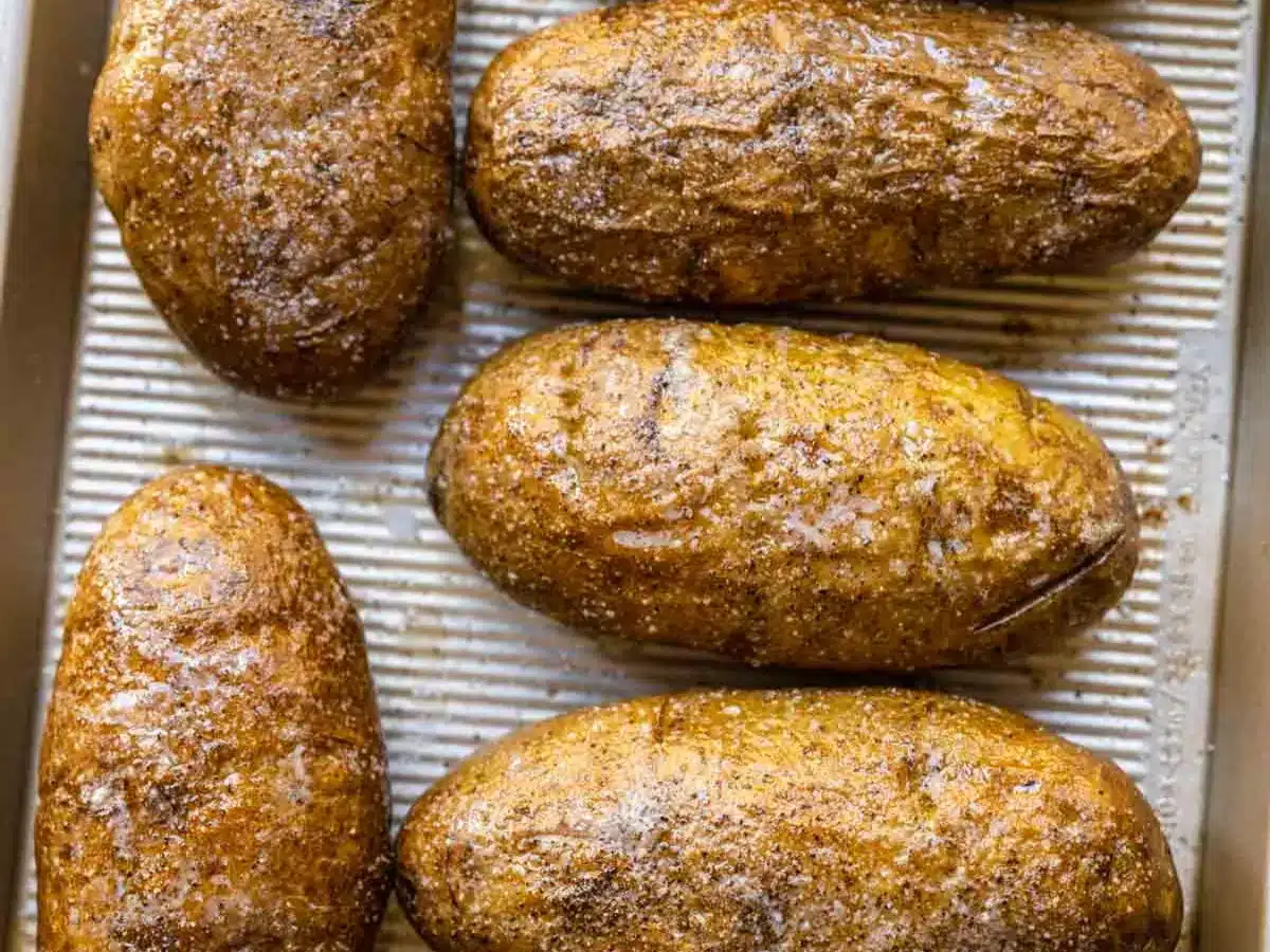 Russet potatoes on baking sheet.