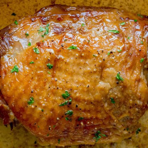 The roasted turkey topped with chopped parsley.