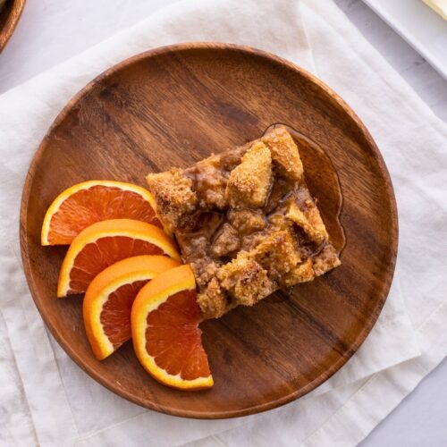 Slice of French toast on a plate with orange slices