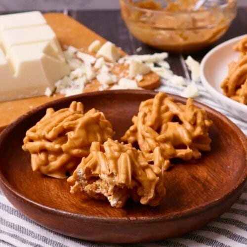 3 finished cookies on a wooden plate.