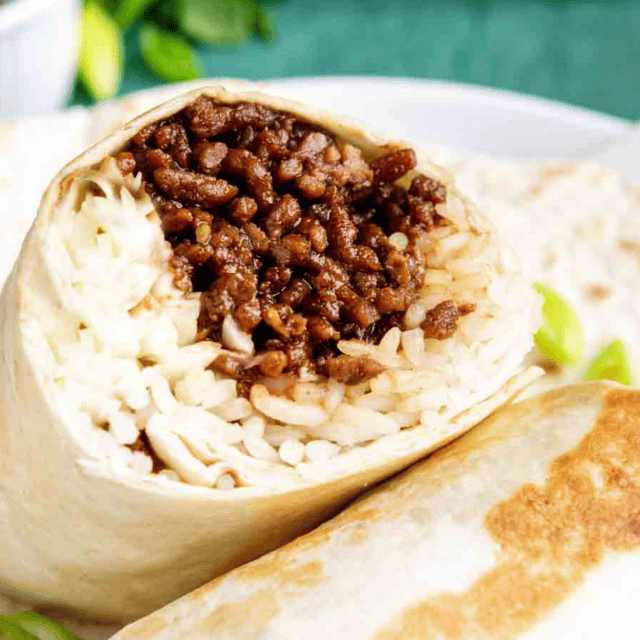 Beef and rice wrapped in a tortilla on a white plate.
