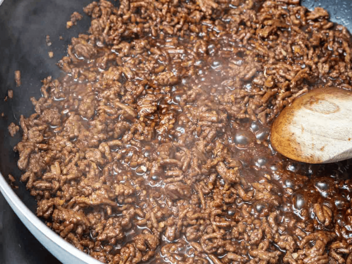 Meat cooking in a pan.