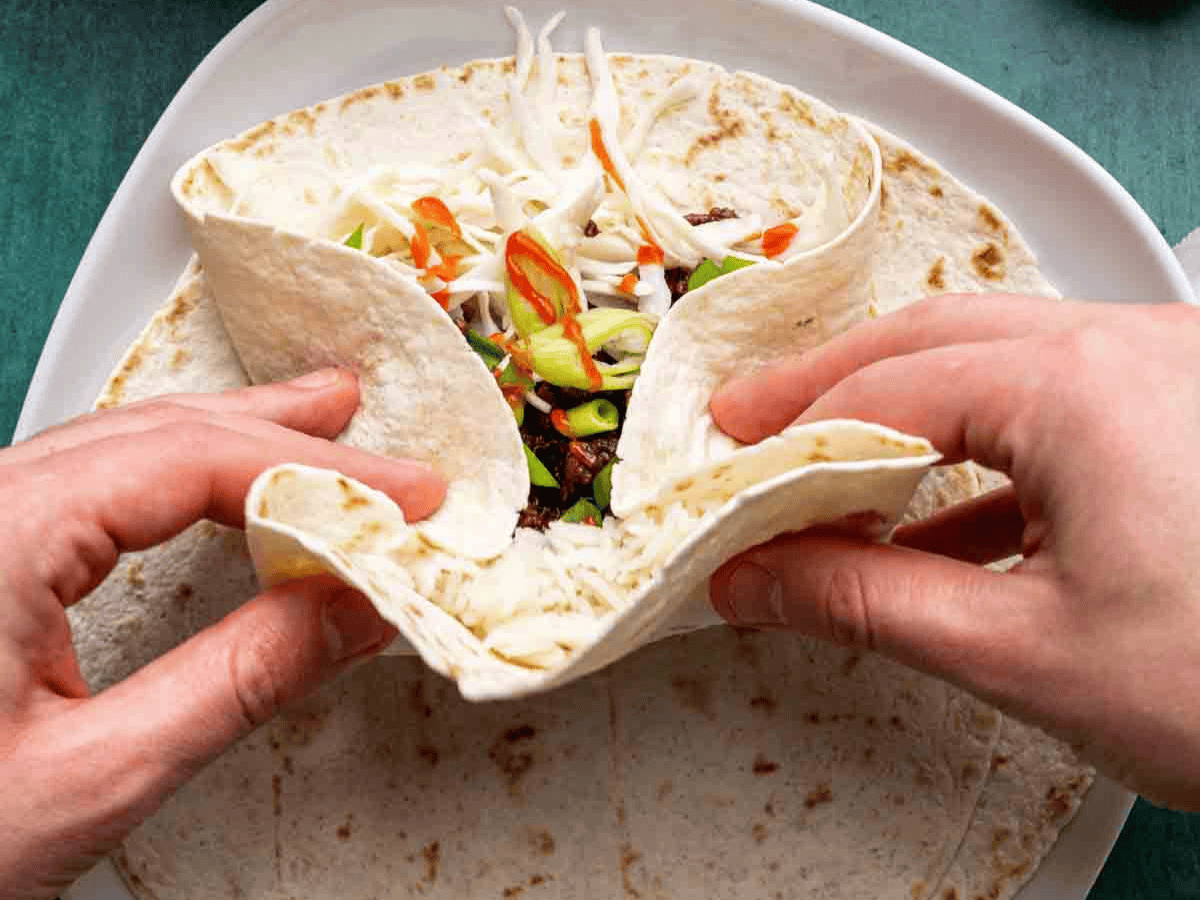 Tortilla wrap being prepared to close.