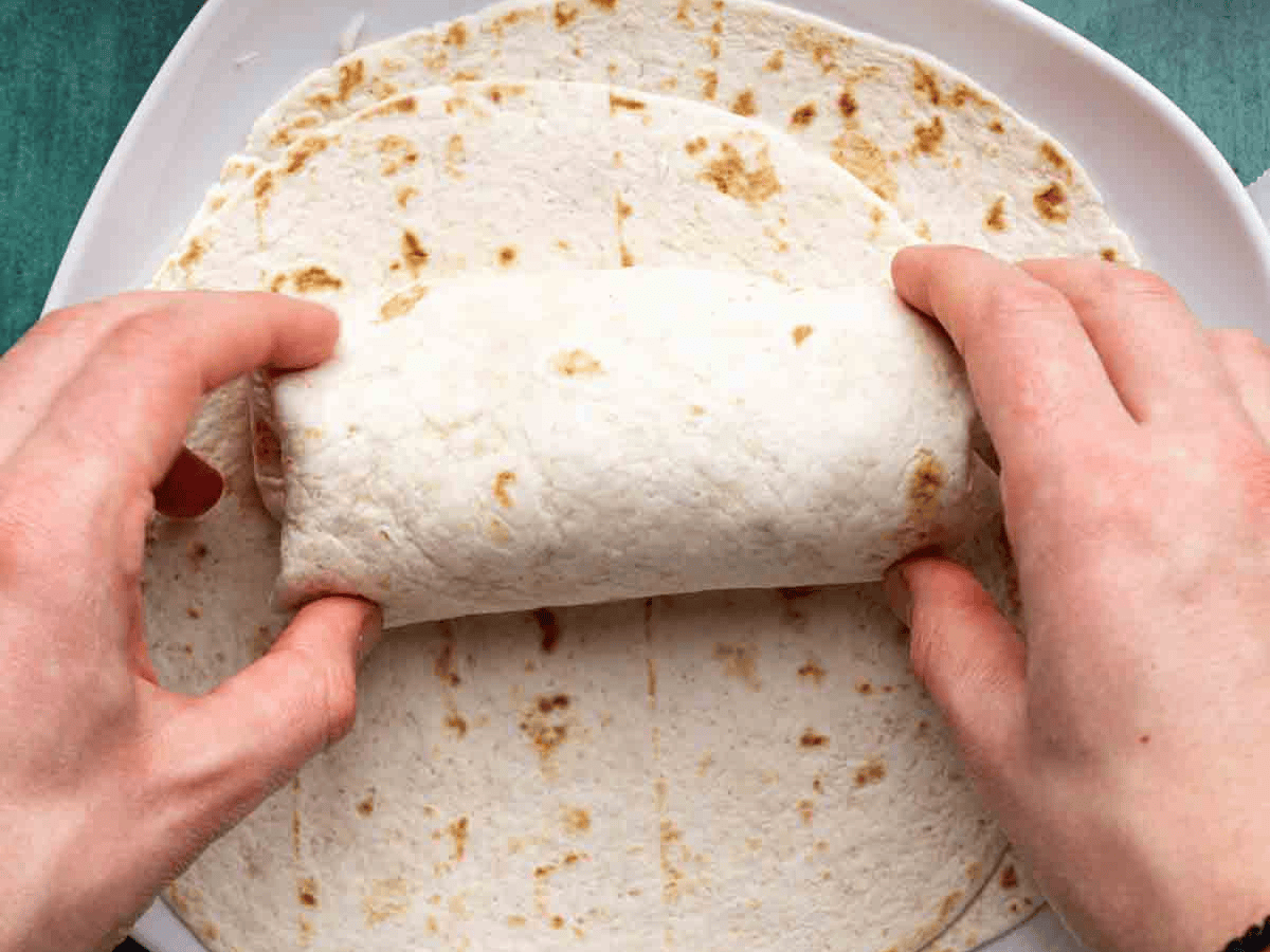 Tortilla completely wrapped around recipe ingredients.