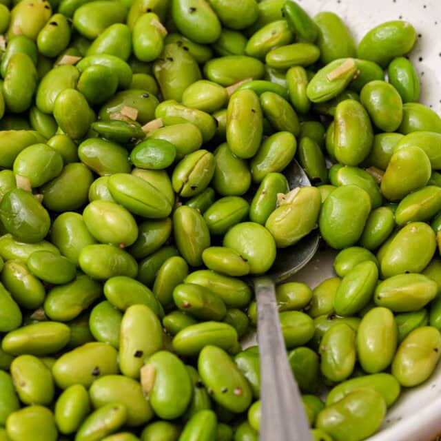 Serving bowl filled with cooked edamame.