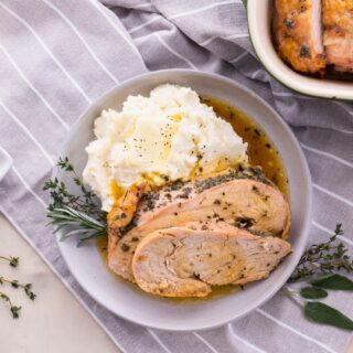 Sliced turkey on a plate with mashed potatoes