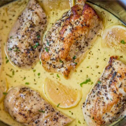 Cooked chicken in slow cooker with sauce.