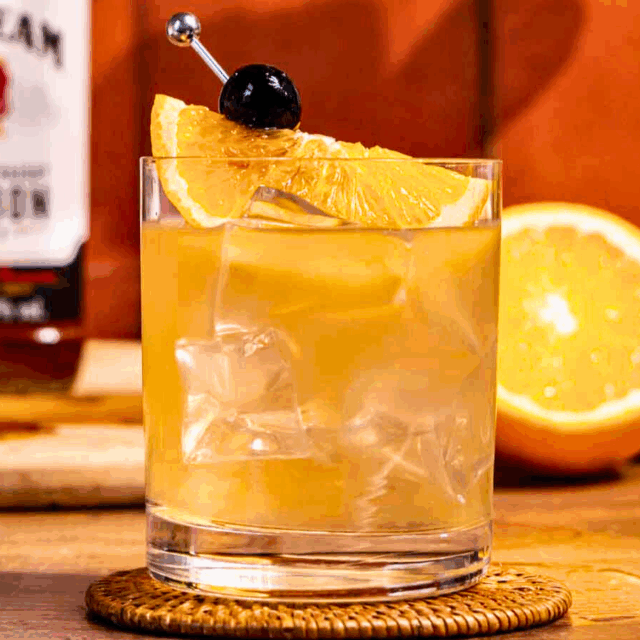 Finished cocktail in short glass with ice and garnish