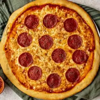 Baked dough with pepperoni on top