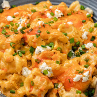 Cooked Mac and cheese plated in bowl with garnishes
