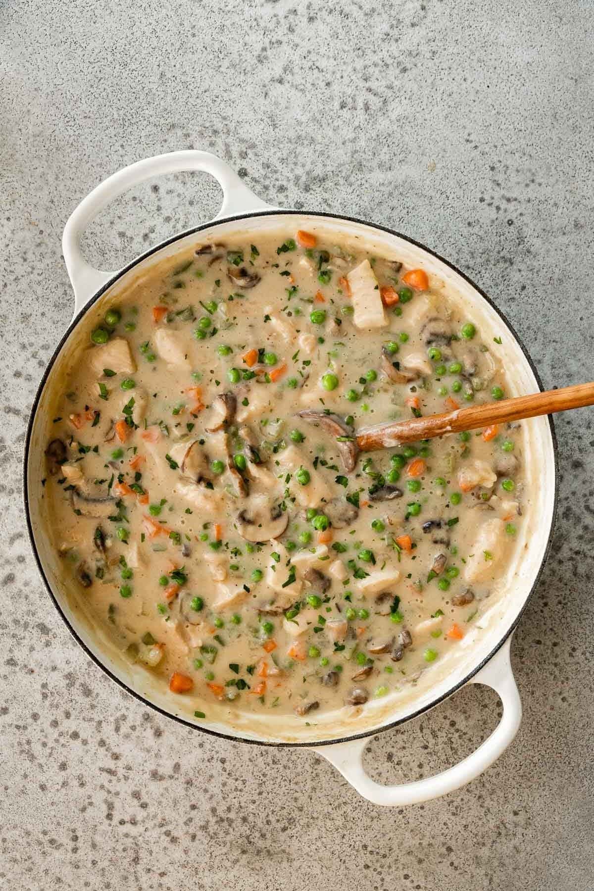 Chicken A La King is a creamy weeknight dinner ready in under 30 minutes with tender chicken, mushrooms, bell peppers, carrots, and peas. Chicken à la King finished cooking in pot