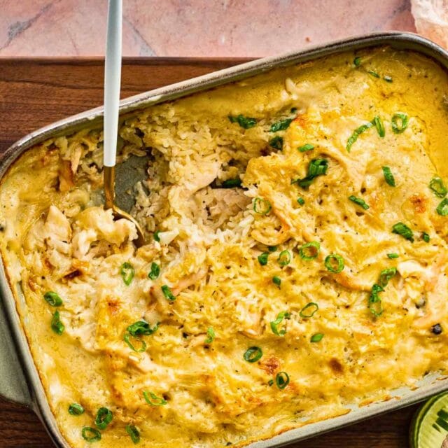 Scooping chicken casserole out of baking dish