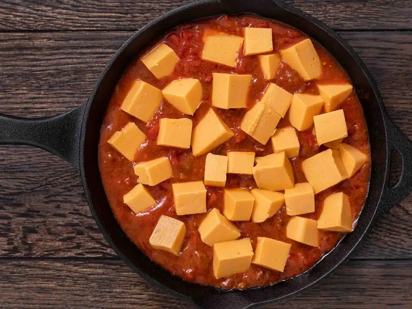 adding cheese into dip 