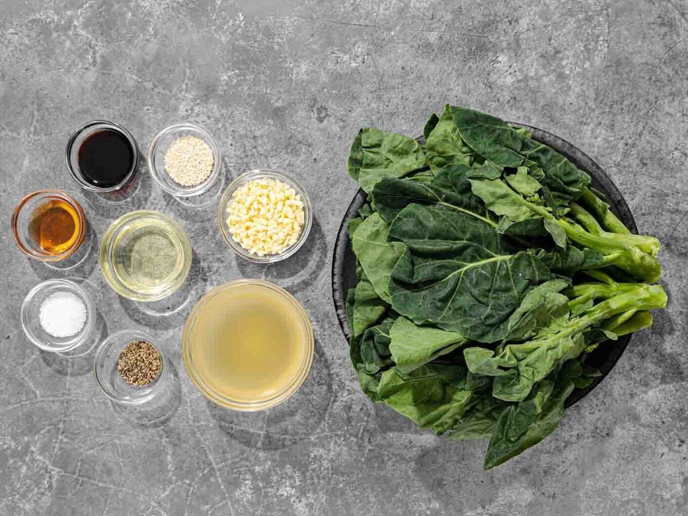 Chinese Broccoli is a delicious quick stir fry flavored with sesame oil, garlic, chicken broth, and soy sauce. Make this easy side tonight! Recipe ingredients laid out on the counter