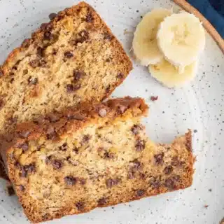 bread on a plate with a bite taken