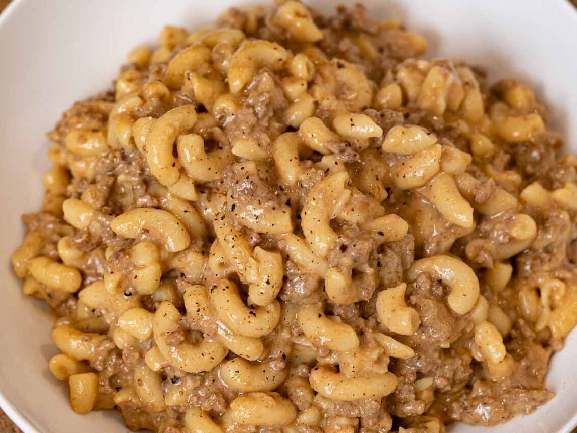 Hamburger Helper is the family friendly dinner you love made from scratch! Quick and easy cheeseburger macaroni, better than the boxed stuff! Made with one-pan and ready in 30 minutes! Plated pasta with sauce in bowl.