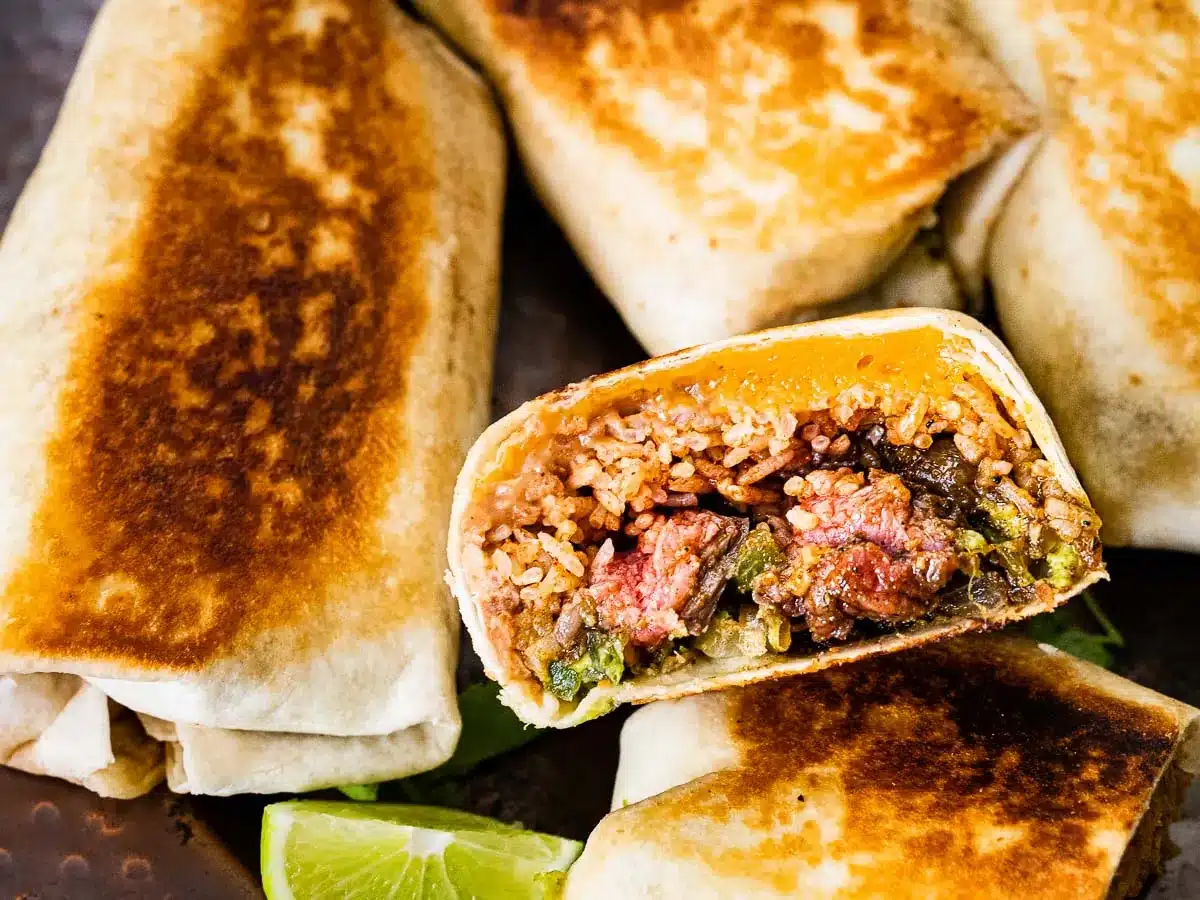 Cooked tortillas filled with ingredients cut in half 