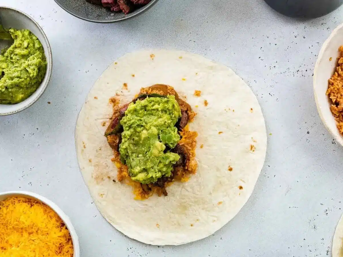 Tortilla filled with rice, steak, and guacamole 