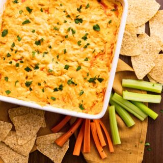Pan of Buffalo Chicken Dip with chips and vegetables on the side