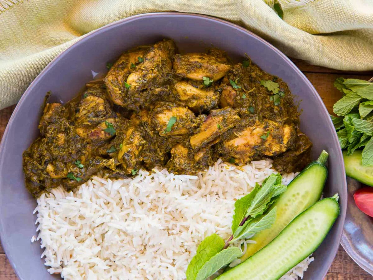 Chicken spinach curry plated in a bowl with rice