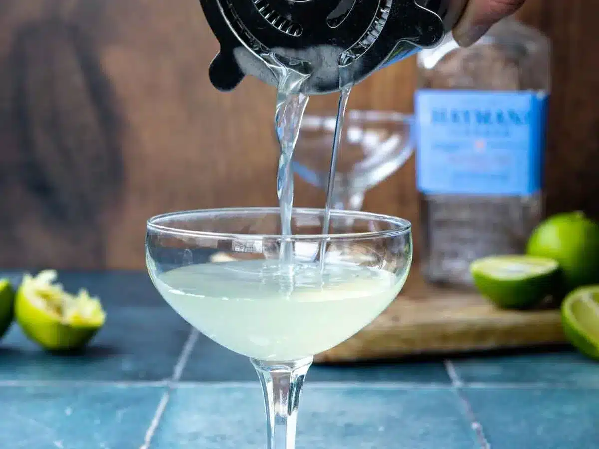 pouring drink into serving glass